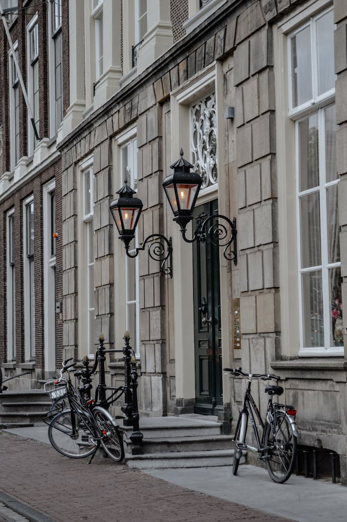 Charming narrow street in Leiden showing classic architecture with bicycles parked by vintage lamp posts.